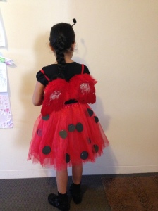 Stuck Black circle cutouts on tutu skirt using stapler, made the antlers using  pipecleaner and pompoms, stuck it on black hairband.